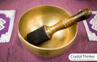 Tibetan bowl (health benefits and how to play it) Golden Tibetan bowl on purple carpet