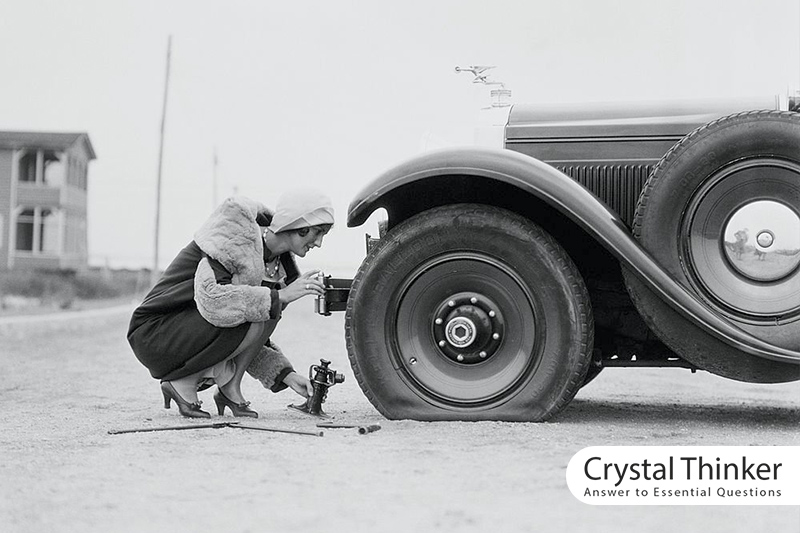 Women's norm-breaking and a lady repairing her car tire
